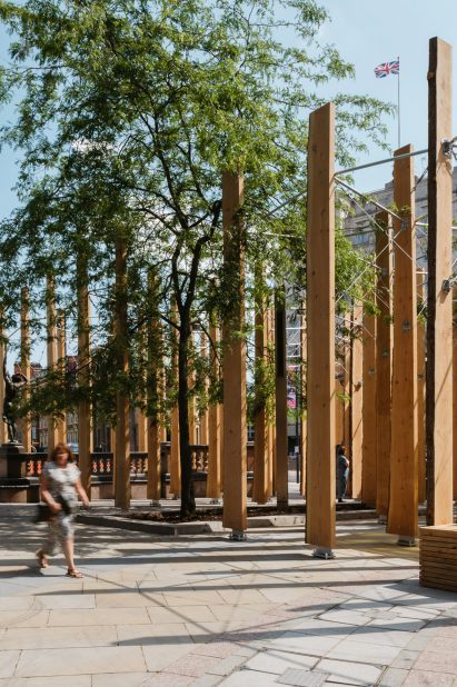 Timber installation Leeds with person walking in foreground