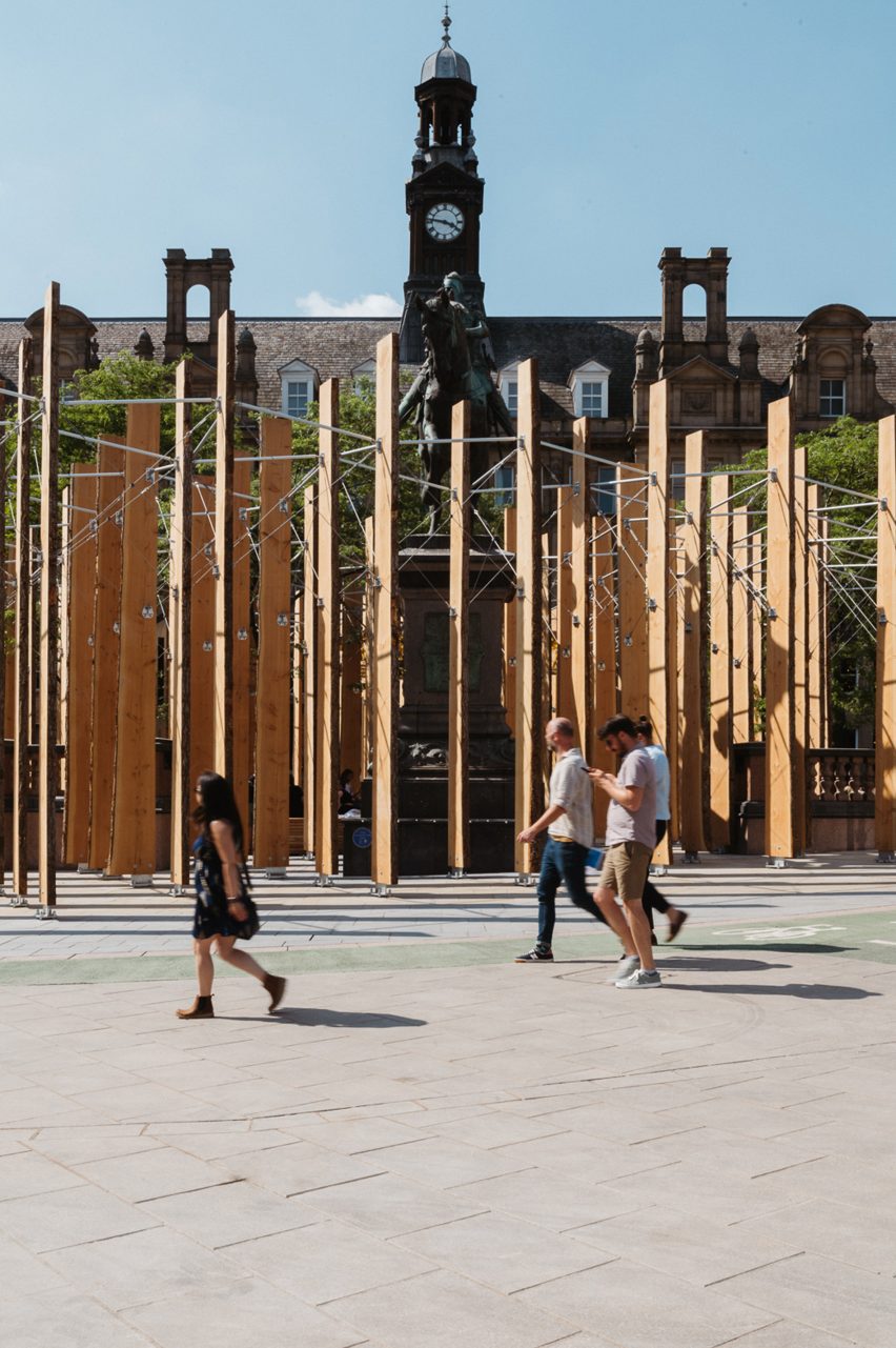 Pedestrians walking in Leeds City Square before Studio Bark and Michael Pinsky installation