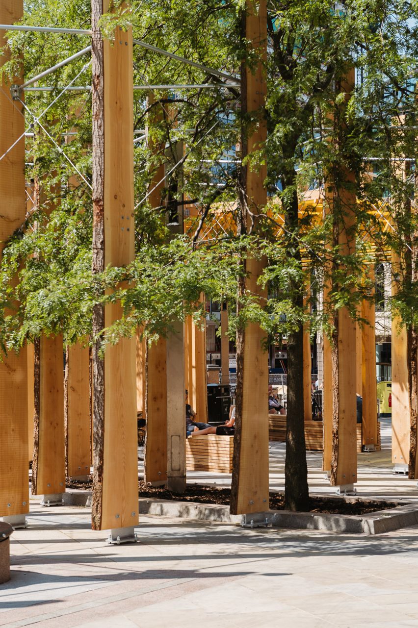 Timber beams in grid formation alongside trees in Leeds City Square