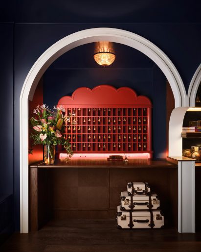 Red key box behind a wooden reception desk