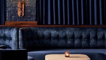 Dark blue lounge with plush banquettes