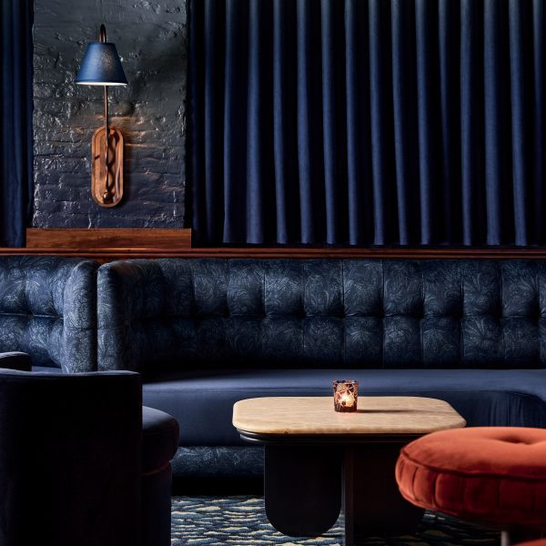 Dark blue lounge with plush banquettes