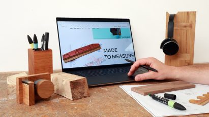 Photograph showing the design stage of repurposing timber offcuts using a laptop, markers, pens and timber samples.