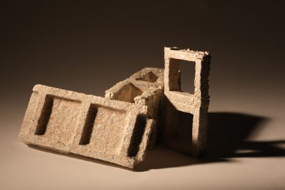 Photograph of material made from mycelium on beige backdrop