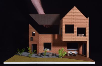 Model on black background with arm removing roof