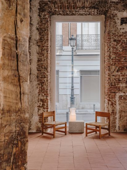Two chairs in front of a tall window in Veja store in Madrid