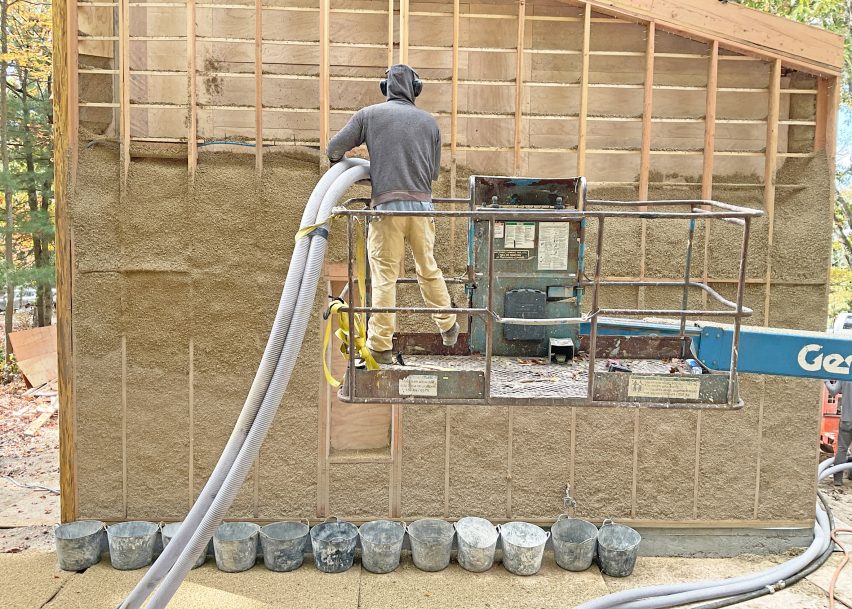 A man spraying hemp insulation