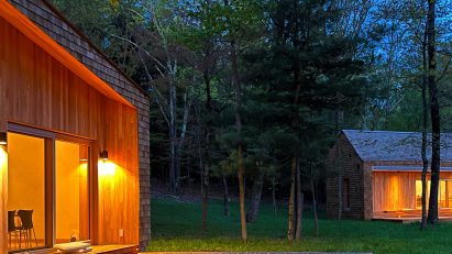 A pair of wooden cabins in the evening