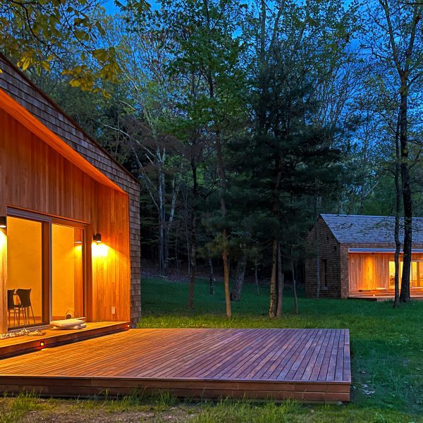 A pair of wooden cabins in the evening