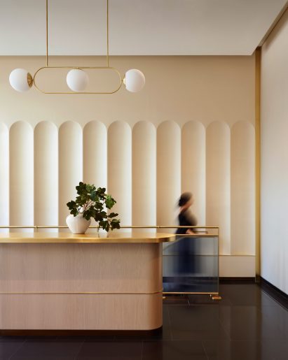 Lobby with brass-topped counter and arched wall niches