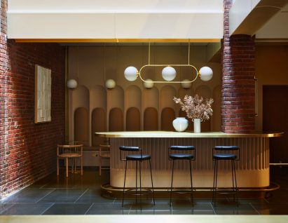 Brass counter with linear chandelier above