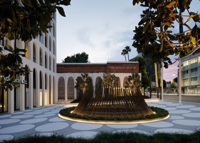 A bronze circular sculpture in a plaza