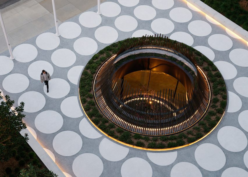 A circular sculptural that surrounds the atruium of a light well