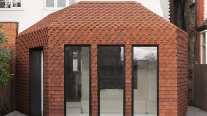 An extension clad in red clay tiles