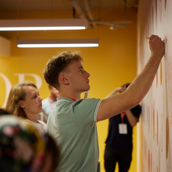 Photo of person writing on a wall