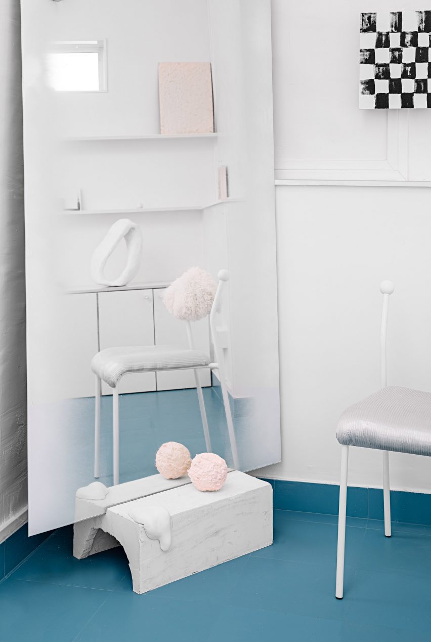 Inside The Act of Quad's studio space, with white furniture and a blue floor