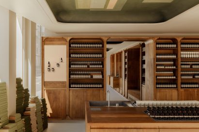 Piles of green books within the Aesop Marylebone store