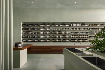 Display of Aesop bottles within wall niche