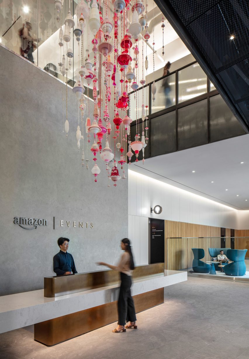 A pink glass sculpture in an Amazon lobby