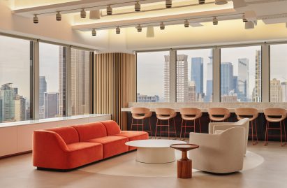 Seating area in front of large windows facing NYC skyline