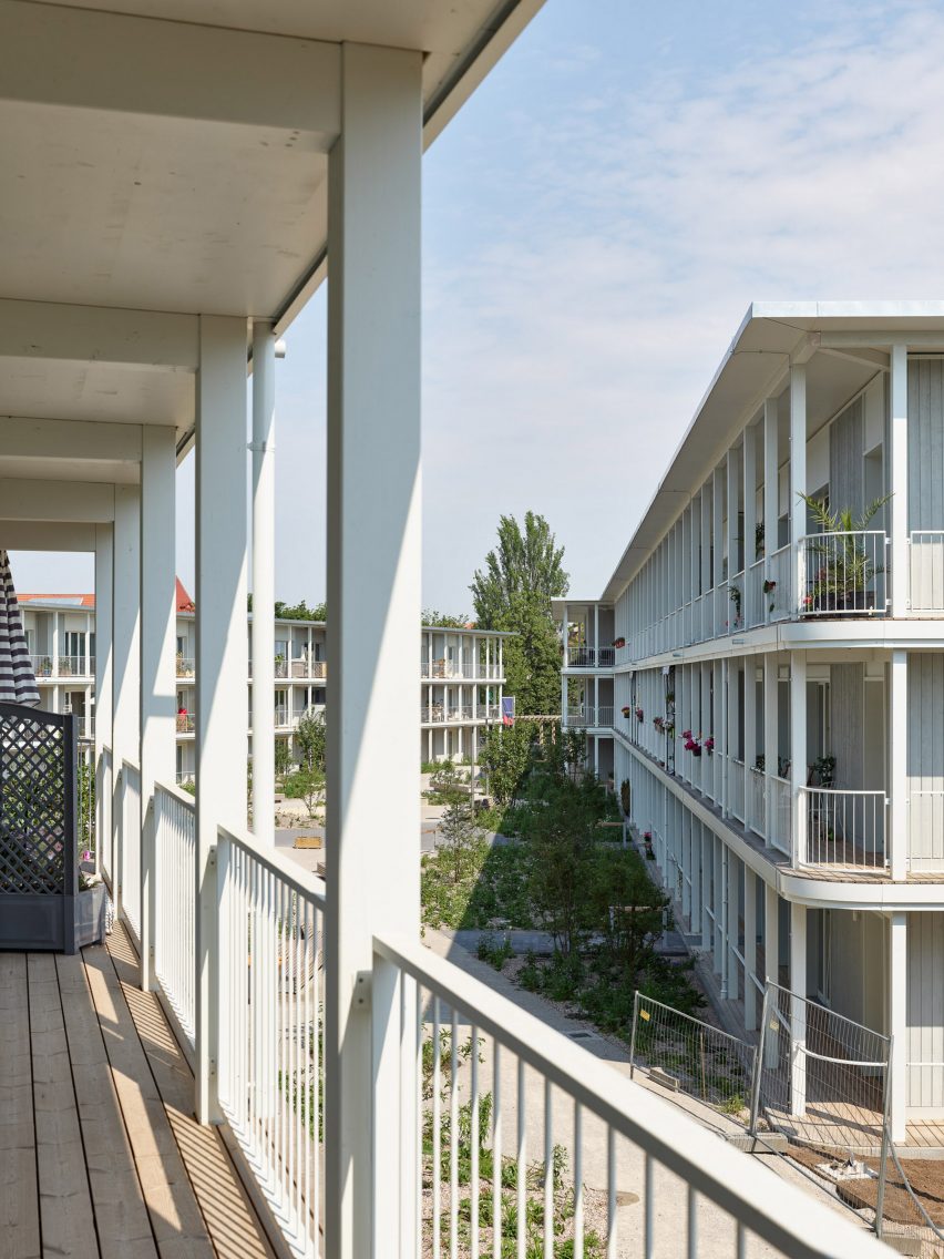Trio of three-storey buildings around a garden with verandas