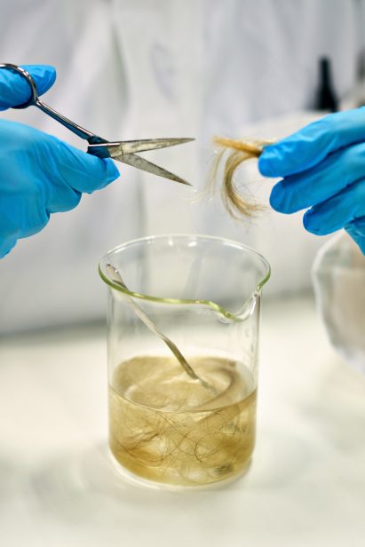 Lab technician putting hair in a jar