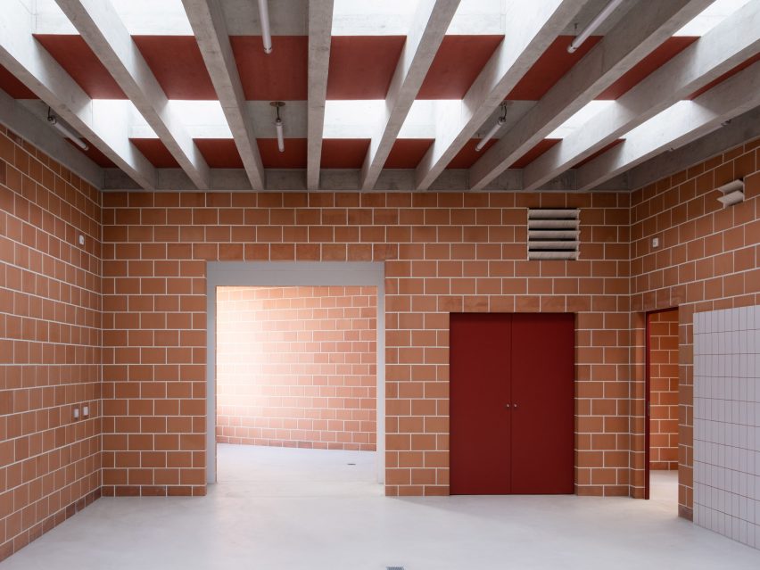 Terracotta brick workshop interior with concrete roof beams