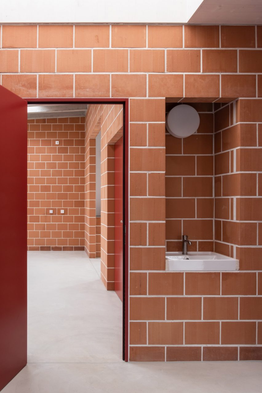 Gardeners workshop interior with red doors and terracotta brick walls