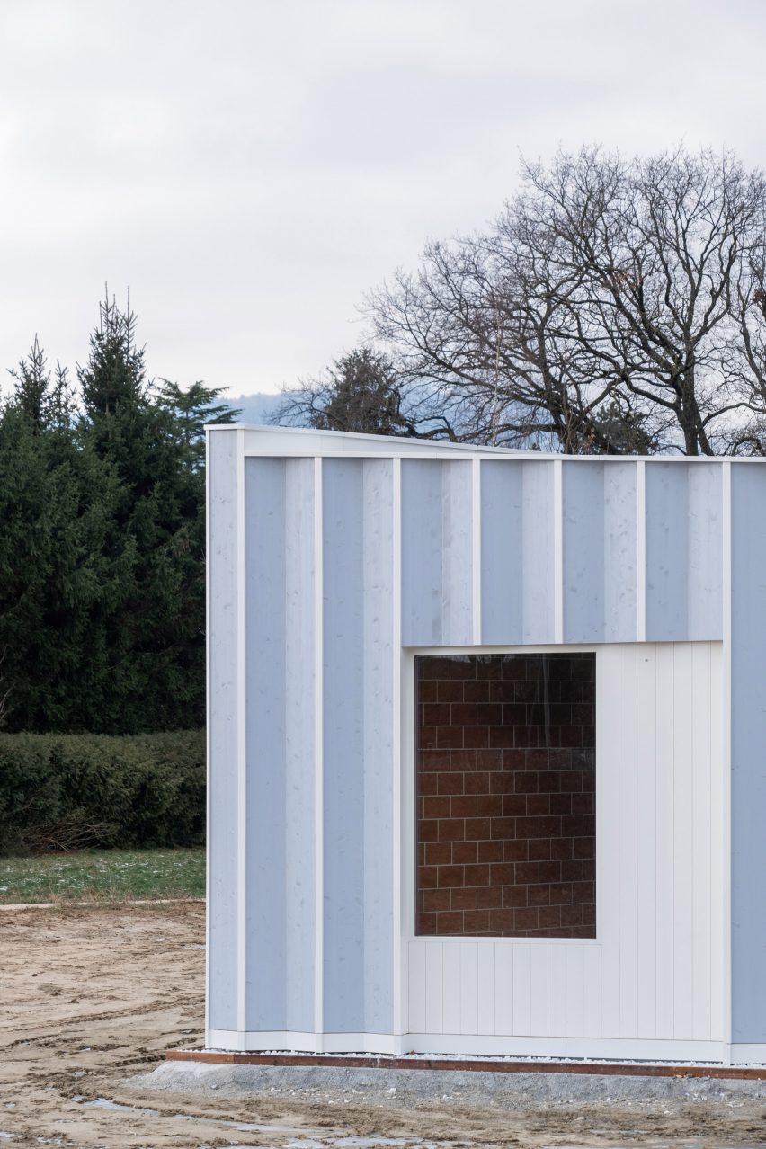 Blue timber gardeners workshop with terracotta brick interior
