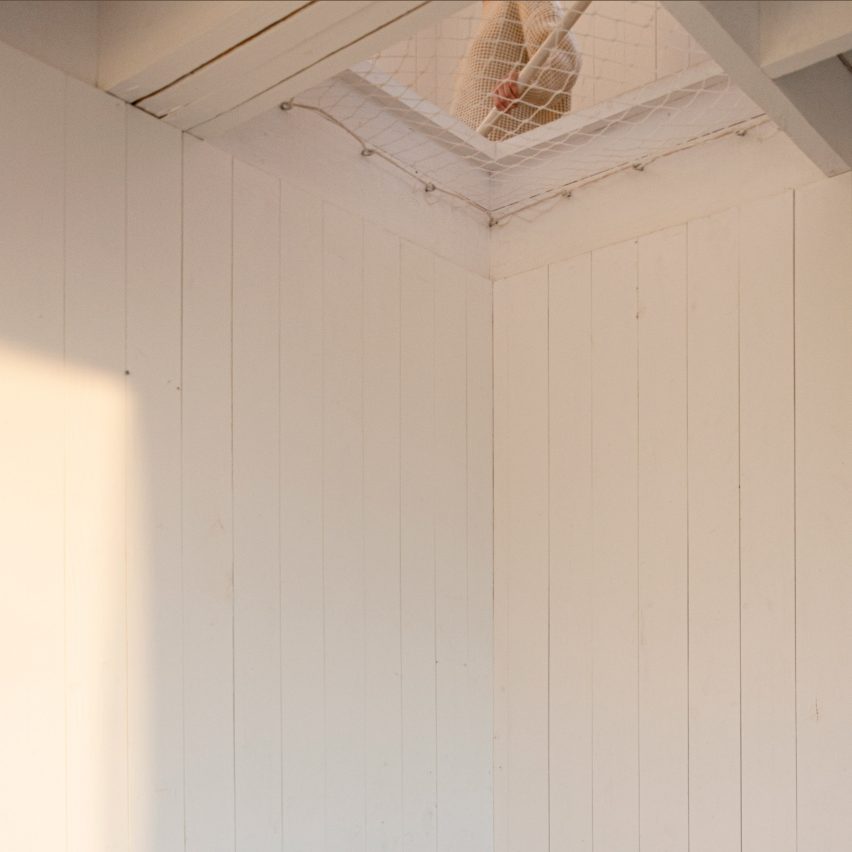 An opening in the ceiling that looks up at a staircase
