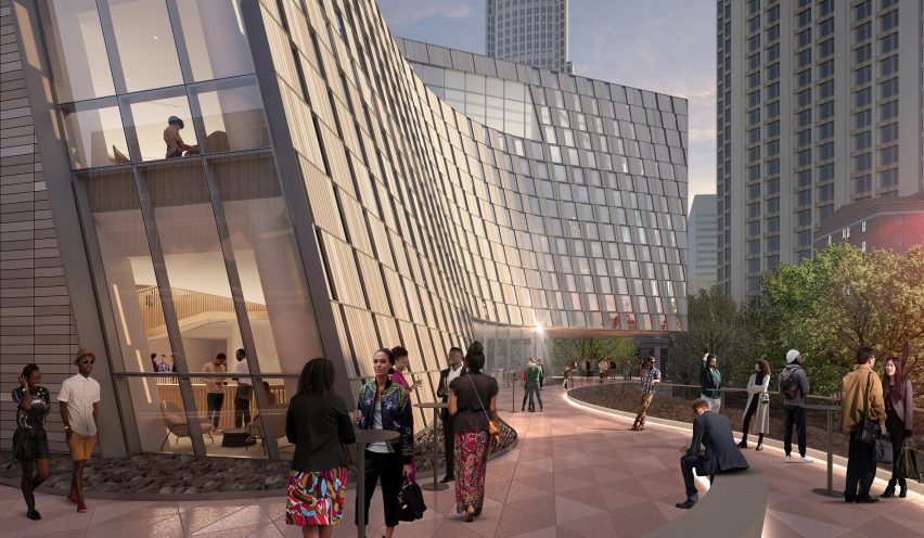 A building with a curving textured facade and spacious terrace