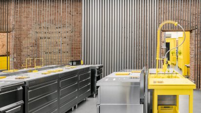 Store interior with stainless steel furniture and yellow sink