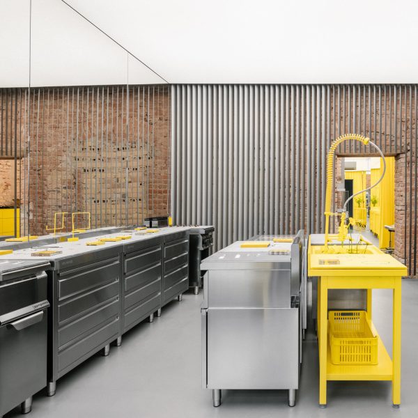 Store interior with stainless steel furniture and yellow sink
