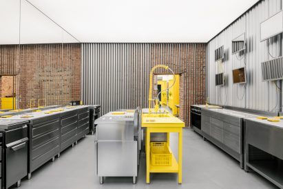 Store interior with stainless steel furniture and yellow sink