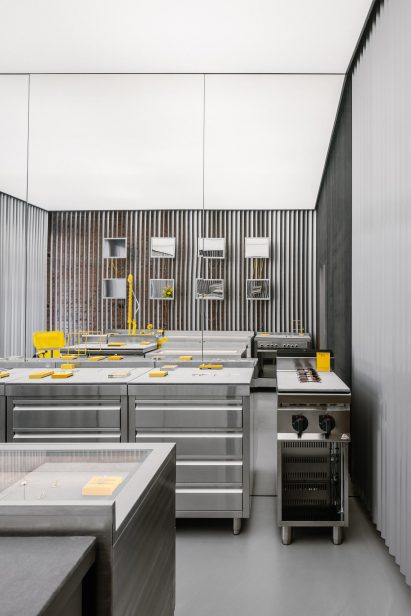 Store interior with stainless steel furniture and yellow sink