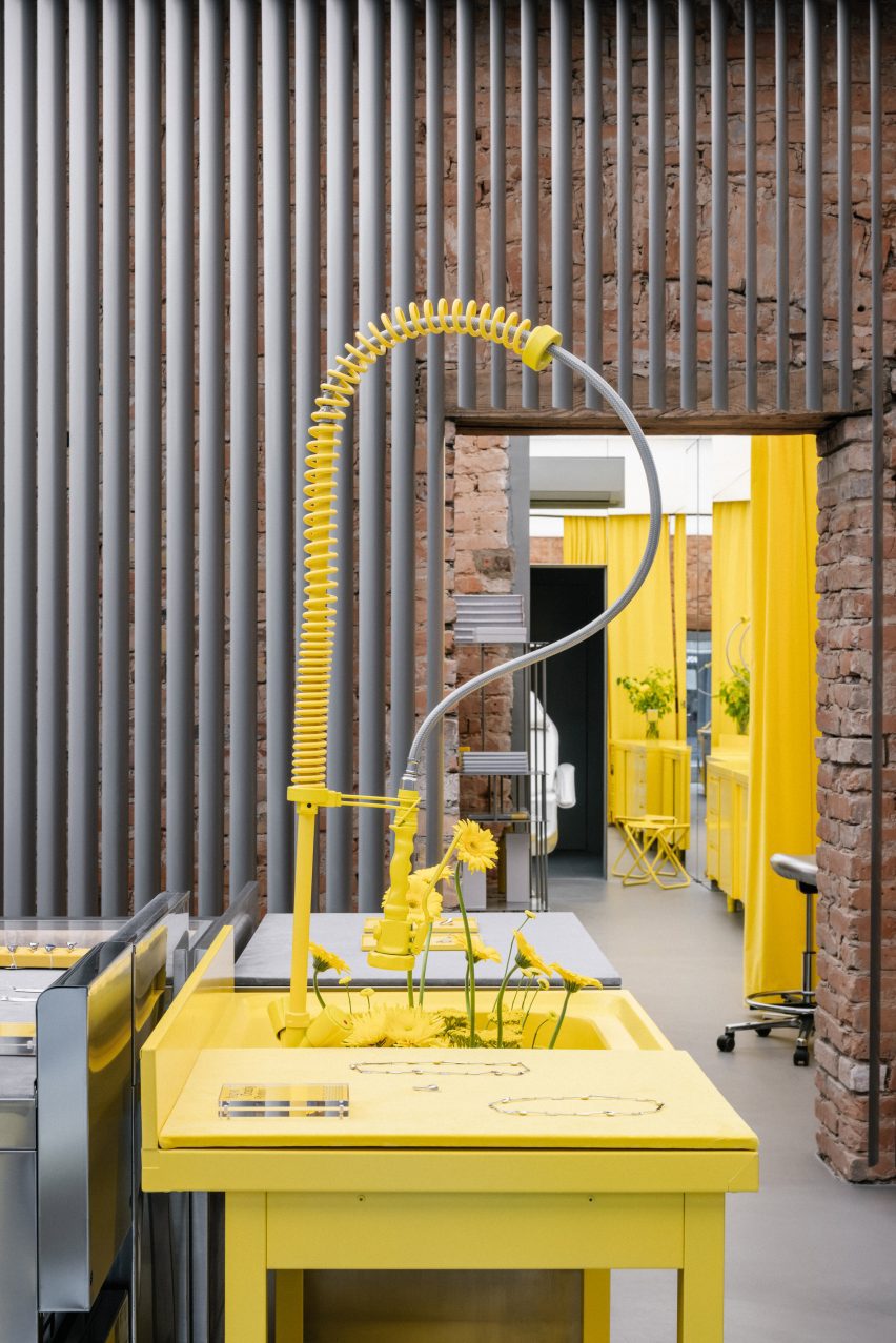 Store interior with stainless steel furniture and yellow sink