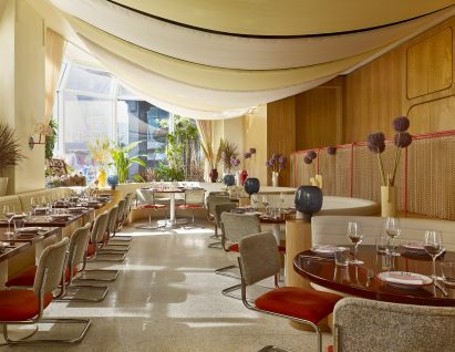 Oxblood red dining tables with booths and Knoll chairs