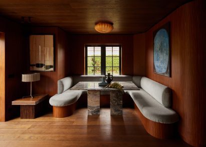 Wood-lined dining room with a built-in seating nook
