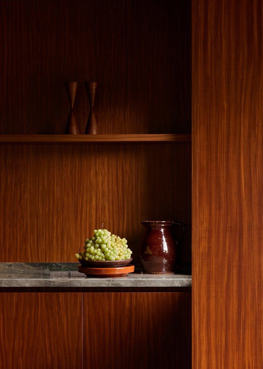 Wood-clad kitchen with a marble worktop