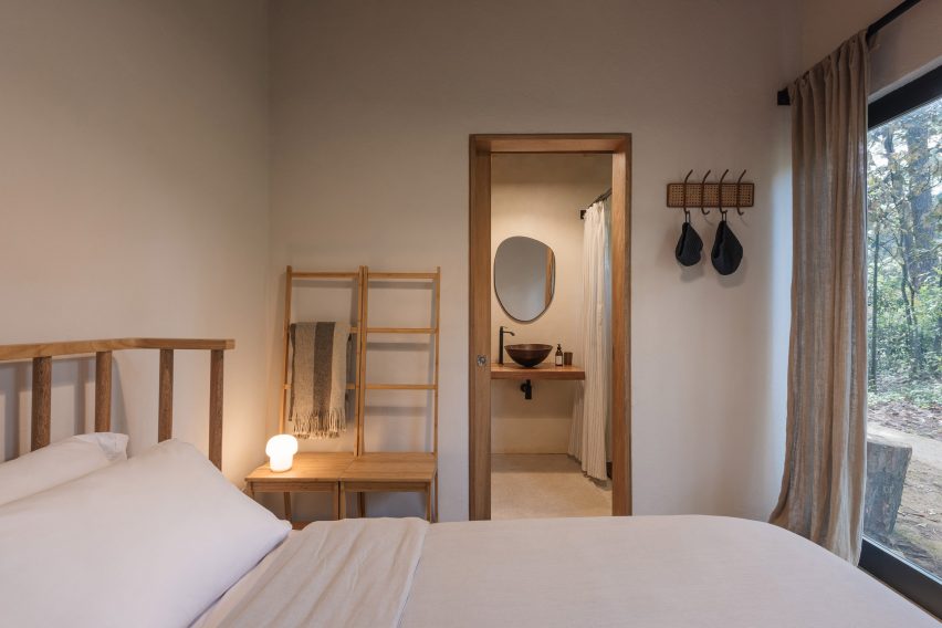 Bedroom with white walls and wooden furniture
