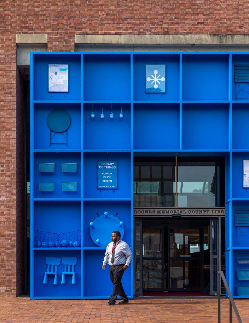 A bright blue cabinet of furniture and objects