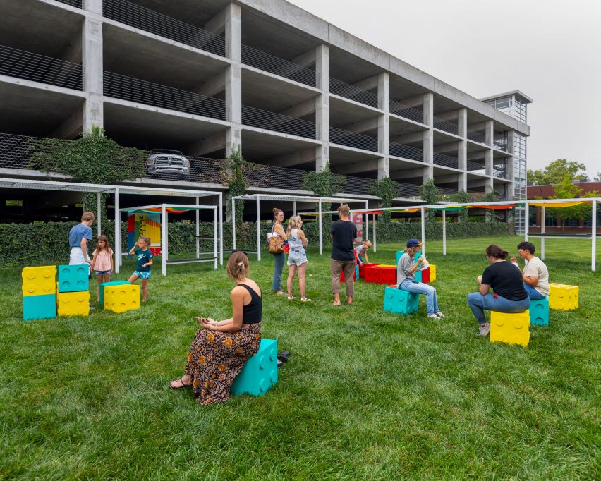 People sitting on brightly coloured boxes