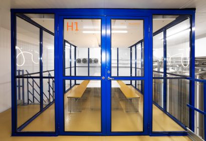 Mezzanine within rectilinear glass and blue-rimmed cube