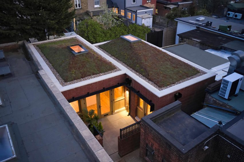 View of Haringey Brick Bungalow showing entrance gate, front courtyard and pyramid shaped green roofs
