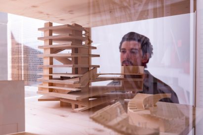 Person looking at Herzog & de Meuron models