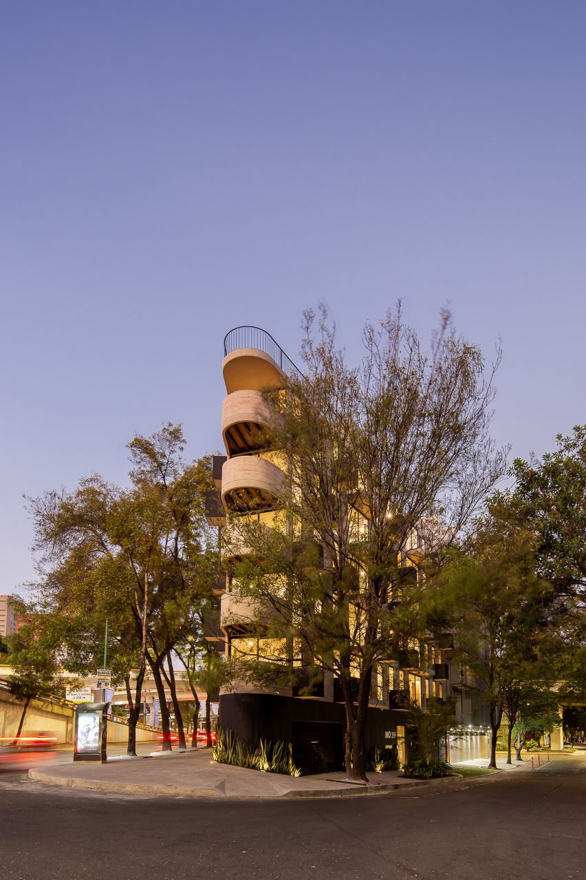 Triangular concrete building with rounded corner by HGR Arquitectos