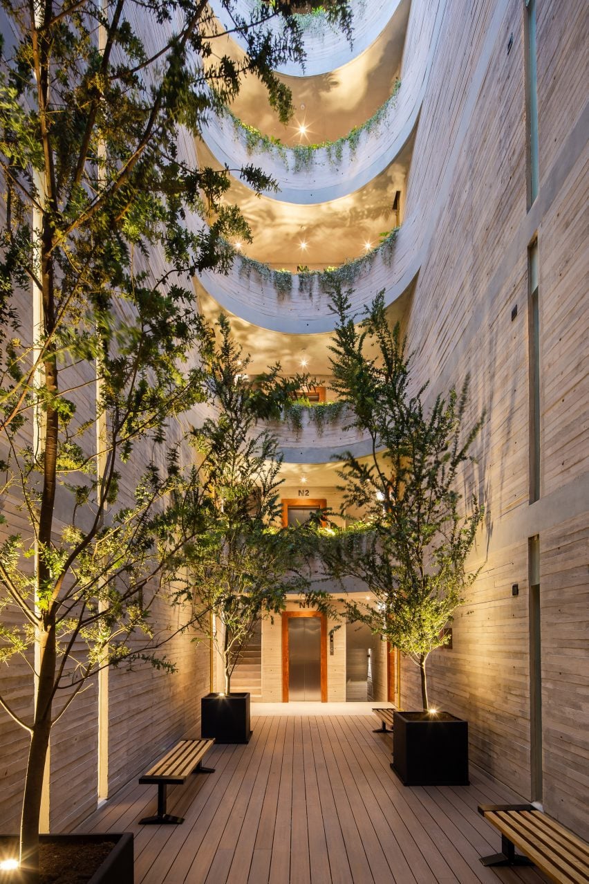 Board-formed concrete courtyard with curved balconies