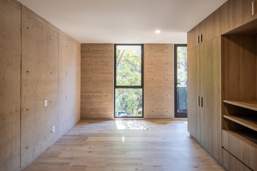 Interior space with concrete walls and timber flooring