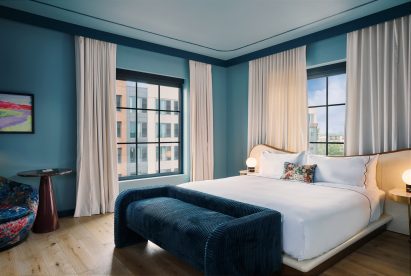Blue guest bedroom with large bed