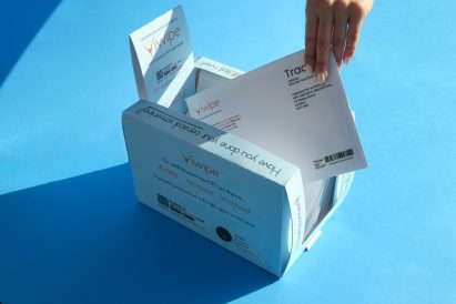 Hand taking test envelope out of box